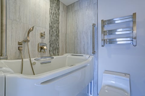Contemporary bathroom design with luxury walk-in bathtub flanked by subway tiled interior accented with glass mosaic tiled vertical stripe