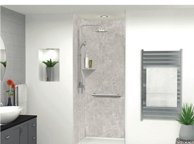Modern bathroom with walk-in shower enclosure, dark vanity with sink, heated towel rack, and potted plants