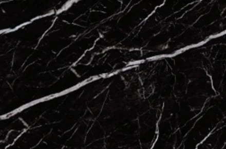 Close-up of black marble surface with white veining and natural stone texture patterns