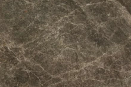 Close-up texture of gray marble or stone surface with natural veining and cracks
